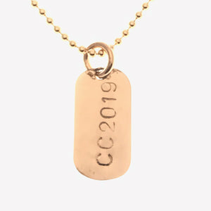 little gold dog tag
